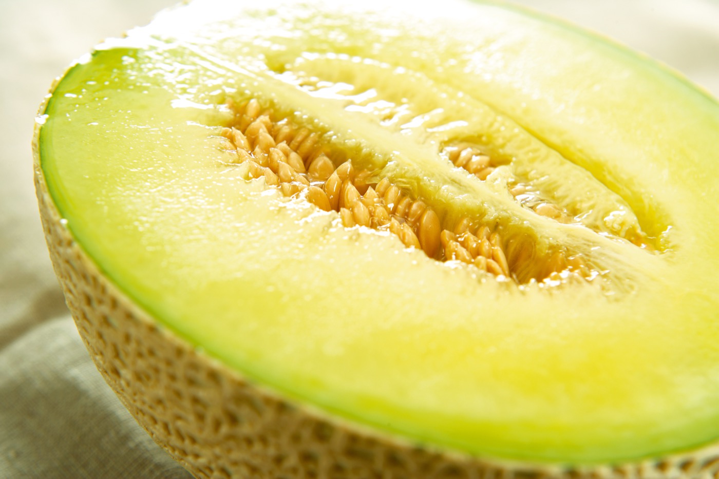 A halved Crown Melon revealing its ripe flesh